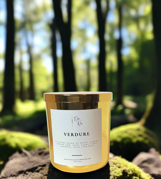 Candle with gold lid and 'Verdure' label on a white background